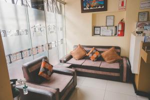 a living room with a couch with pillows on it at Kaaro Hotel Puno in Puno