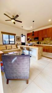a kitchen and living room with a ceiling fan at San Angel Villas in San Antonio