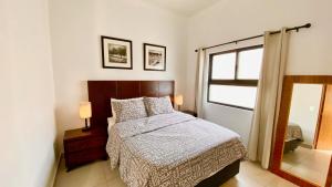 a bedroom with a bed and a window and a mirror at San Angel Villas in San Antonio