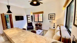 a living room with a table and a couch at San Angel Villas in San Antonio