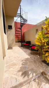a patio with benches on the side of a building at San Angel Villas in San Antonio
