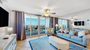 a living room with a couch and a large window at Sunset Haven in Destin