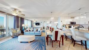 a living room with a kitchen and a dining room at Sunset Haven in Destin