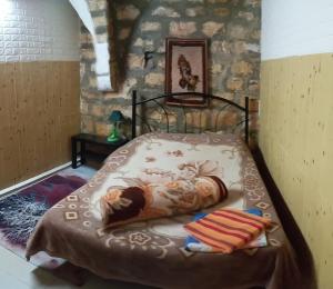 a bedroom with a bed with a cow on it at Jaffa Gate Hostel in Jerusalem