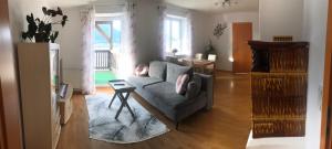 a living room with a couch and a table at Ferienwohnung Lechnerhof in Tiefgraben
