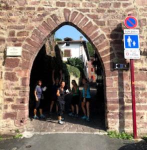 a group of people standing in a brick archway at La vita e bella in Saint-Jean-Pied-de-Port