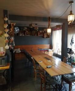 a dining room with a large wooden table and chairs at La vita e bella in Saint-Jean-Pied-de-Port