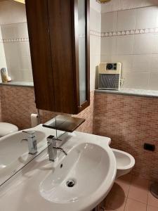 bagno con lavandino bianco e specchio di Grandze du Pleiney a Saint-Rhémy-en-bosses