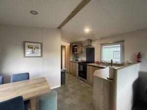 a small kitchen with a table and a counter top at Sleepy Hollow Holiday Home in Knaresborough