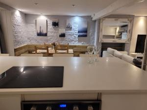 a kitchen and living room with a white counter top at Beach Walk Sandgate in Sandgate