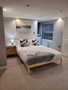 a bedroom with a large bed in a room at Beach Walk Sandgate in Sandgate