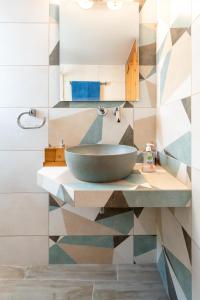 a bathroom with a bowl sink on a counter at Alexandra's Cozy Sea View Apartment in Argostoli