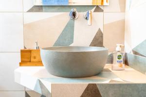 a bathroom with a large bowl sink on a counter at Alexandra's Cozy Sea View Apartment in Argostoli