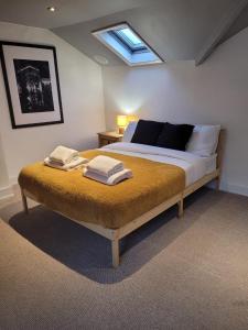 a bedroom with a bed with two towels on it at Sea View Sandgate in Sandgate