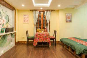 a dining room with a table and two beds at Hanoi Retro 80S Homestay in Hanoi