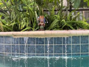a statue sitting in the middle of a water fountain at Poolside Cocoa Oasis w/ Tiki Bar! in Frontenac