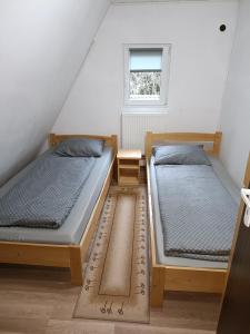 two twin beds in a room with a window at Green House in Gheorgheni