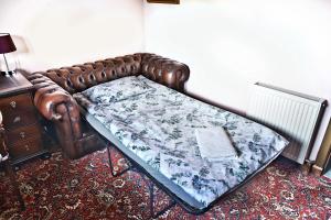 a bed in a room with a blanket on it at A cosy house near the city centre in Glasgow