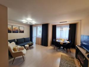 a living room with a blue couch and a table at Mountain Peak Apartment in Borovets