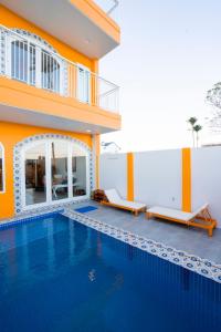 a house with a swimming pool next to a building at Shadyside 4: Smoothies Mango house in Tân Thành (1)