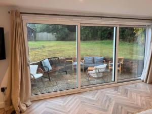 a screened in patio with chairs and a table at Beautiful 5 bedroom home ideal for large groups in Ryde