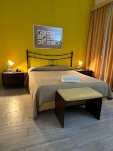 a bedroom with a bed and two nightstands and a table at Hotel Le Calandre in Rubano