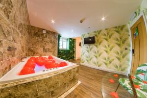 a large bathroom with a tub with a glass table at Thomas Wright House in Byers Green