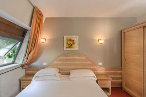 Postel nebo postele na pokoji v ubytování Hotel Nedy