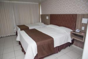 A bed or beds in a room at Hotel Village