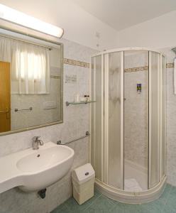 a bathroom with a sink and a shower at Hotel Nedy in Marina di Massa