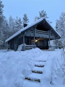 a house with a pile of snow in front of it at Siljonranta in Muonio