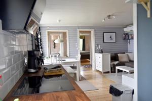 a living room with a couch and a table at Lakeside cottage in Lapland with great view in Skaulo