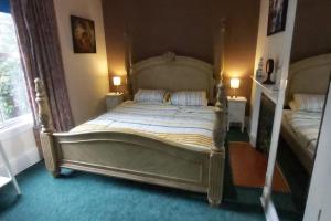 a bedroom with a large bed in a room at Country Mansion - Private Annexe in Llanwrda
