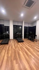 a room with a gym with a wooden floor at MyNest1103A@SweetHome in Melaka