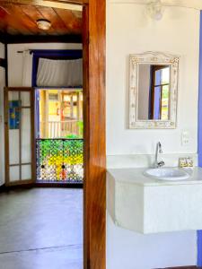 a bathroom with a sink and a mirror at Vila Pequeá Ilhabela in Ilhabela +37 photos