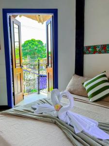 um quarto com uma cama com uma toalha em Vila Pequeá Ilhabela em Ilhabela