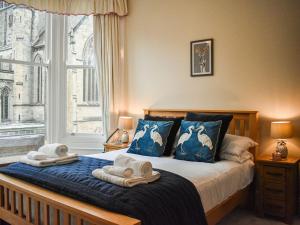 a bedroom with a bed with towels on it at Stanton House - Abbey View in Whitby
