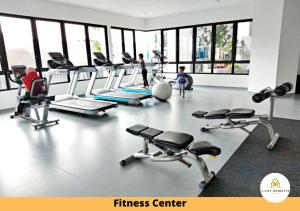 a fitness center with a bunch of exercise equipment at I-City Homestay - Shah alam, Hospital Shah Alam, UITM, Central Mall SOGO, Seksyen 7 in Shah Alam