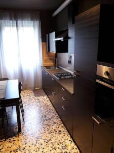a kitchen with stainless steel appliances and a table at Casa Teodora in Mantova
