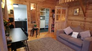 ein Wohnzimmer mit einem Sofa und einer Küche in der Unterkunft 'Monktonmead Lodge' in secluded setting, with private indoor pool. in Ryde
