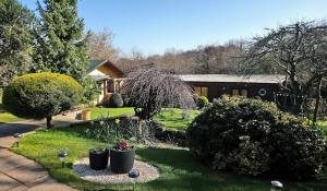 En have udenfor 'Monktonmead Lodge' in secluded setting, with private indoor pool.