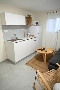 a kitchen with a sink and a table in a room at פסגת הדרור in Shelomi