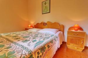 a bedroom with a bed and a table with two lamps at Seaside Apartments Markota in Blato