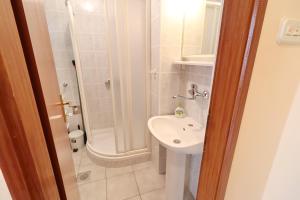 a small bathroom with a sink and a shower at Seaside Apartments Markota in Blato +21 photos