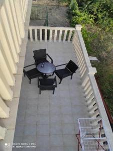 a patio with four chairs and a table on a porch at Holiday Home Carević in Gornja Brela