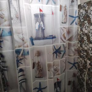 a room with a curtain withautical items on it at La CASETTA A ZANZIBAR B&B in Uroa