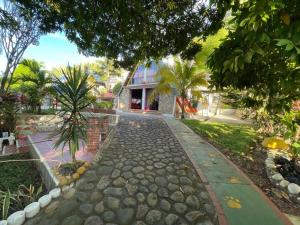 a stone path in front of a house at QUINTA PRIVADA Jamani Melgar in Melgar