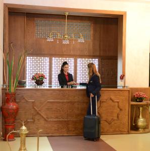 two women standing at a bar with a luggage at El Yacouta in Tetouan