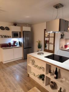 a kitchen with white cabinets and a counter top at Nid douillet in Gréolières