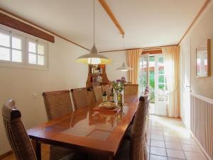 a dining room with a wooden table and chairs at Villa les Bois 10 pers in Nadalie